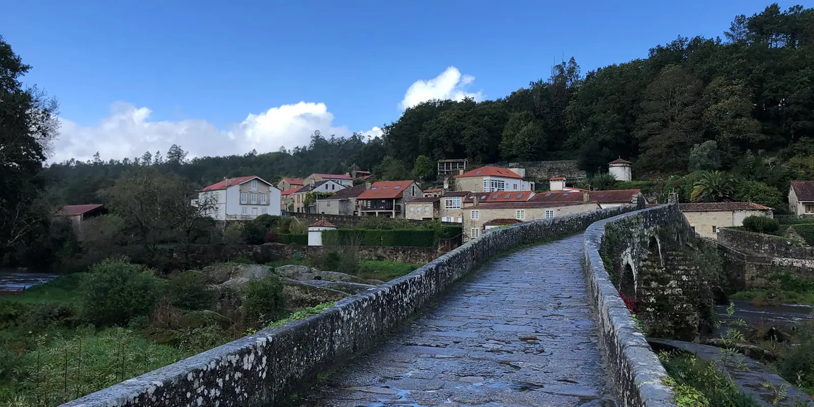 stone bridge over river near small Spanish town