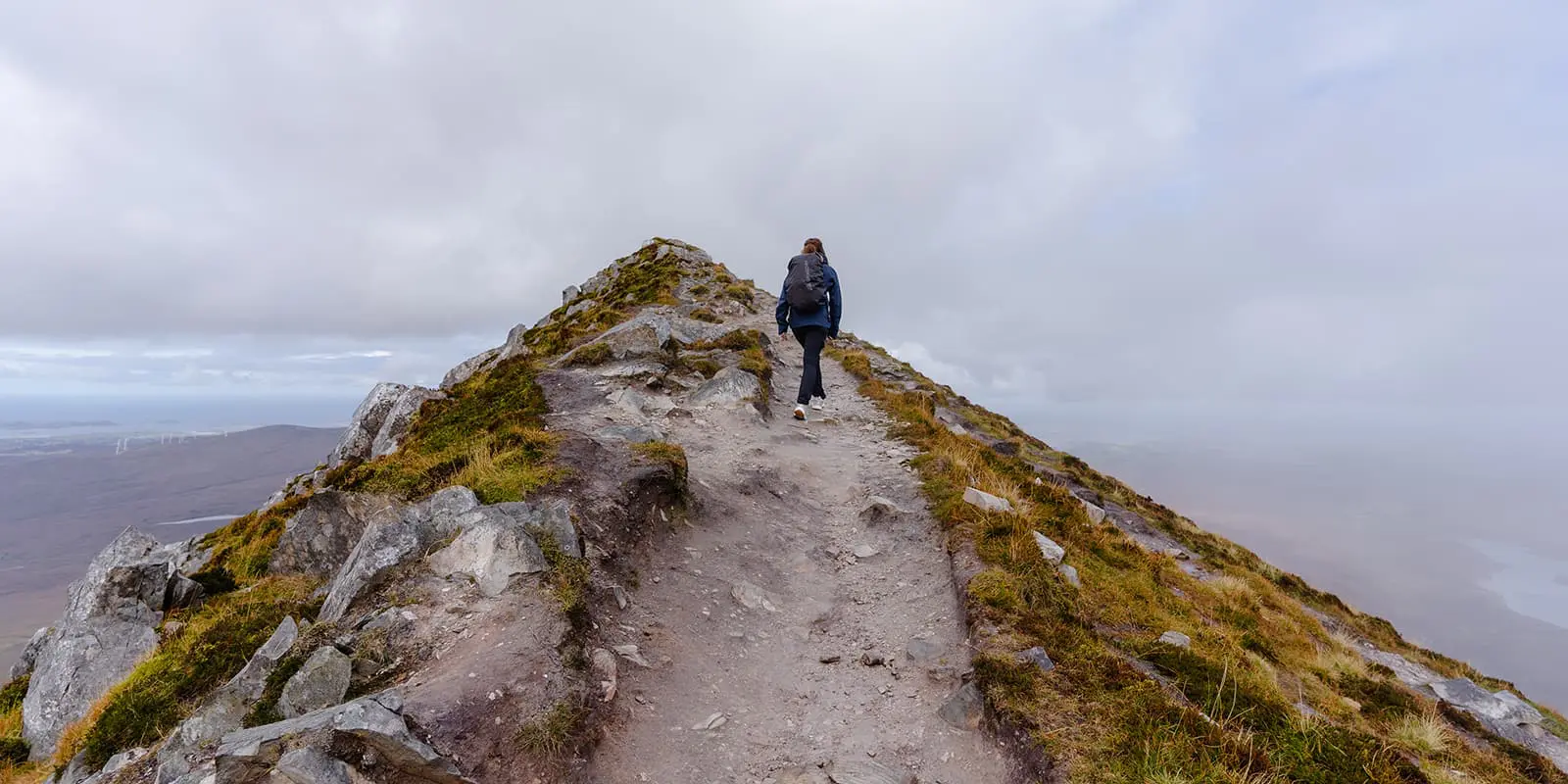 person hiking up mount errigal