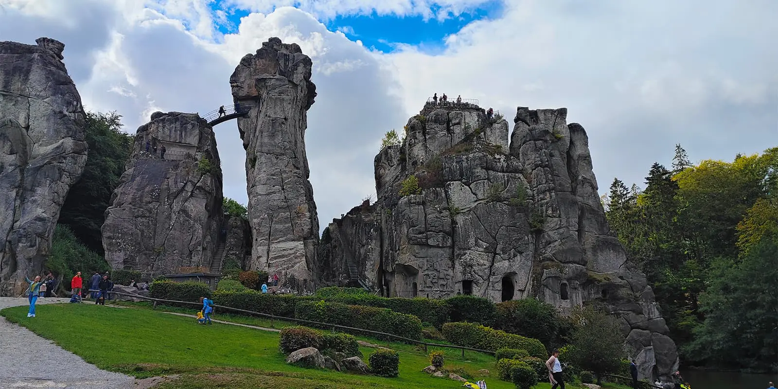 people near the Externsteine rock formation in Germany