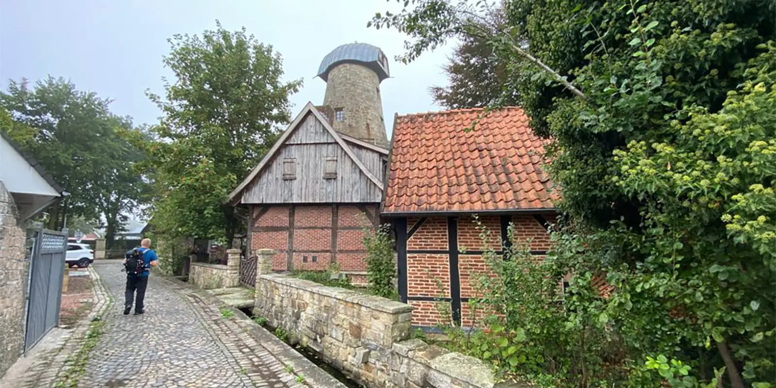 person hiking through small town in Germany on the Hermannsweg