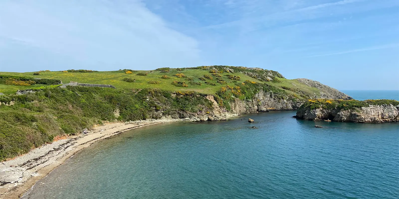 green coastline near ocean on the Wales coast path