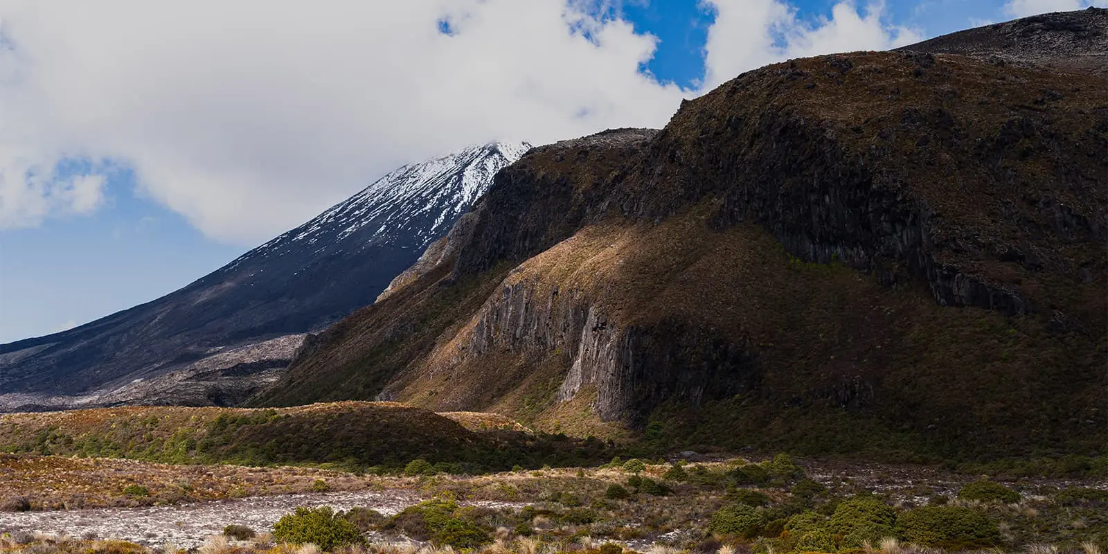 sun hitting side of mountain in New Zealand's Tongariro national park