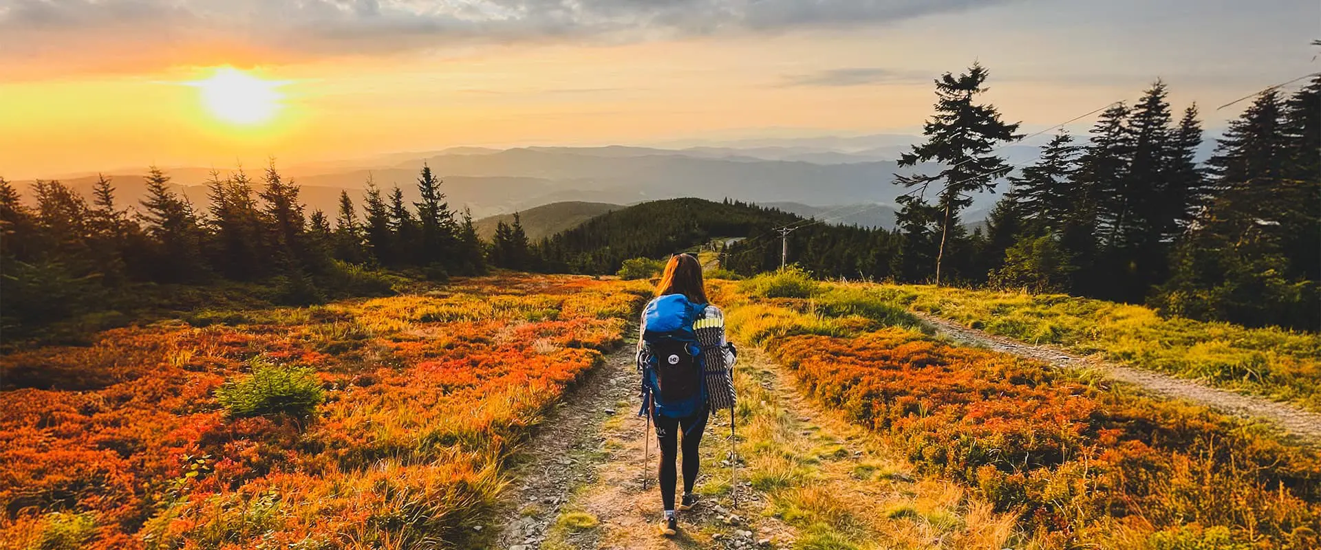 women hiking down colorful hills during sunrise on the Czech Trail