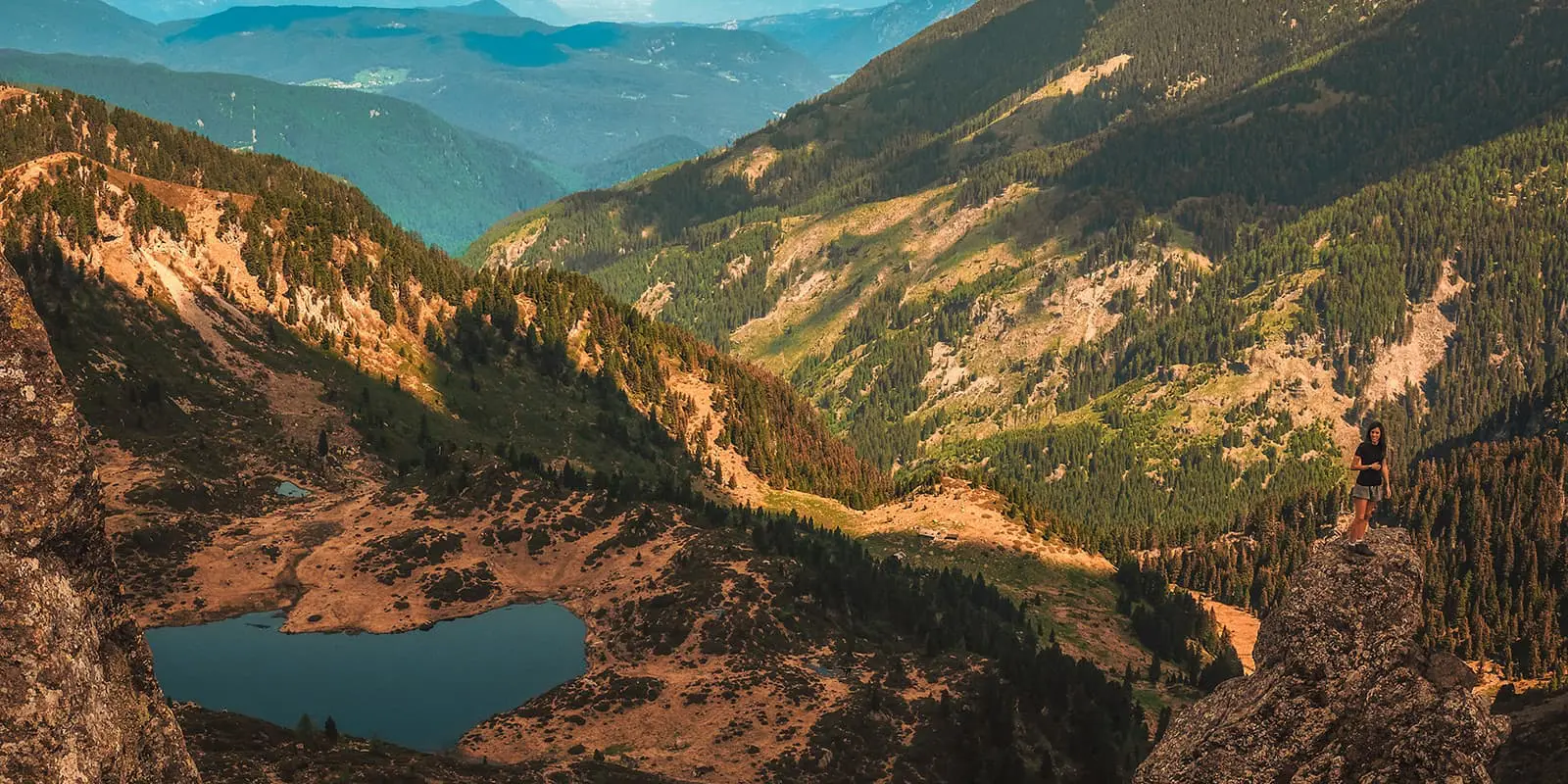 aerial view of lake surrounded by mountains in Italy