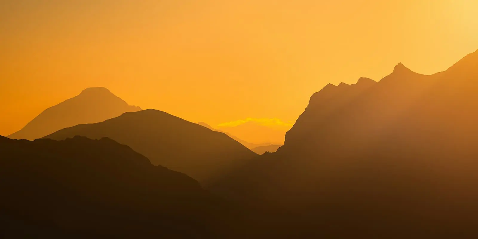 silhouet of mountains at sunset