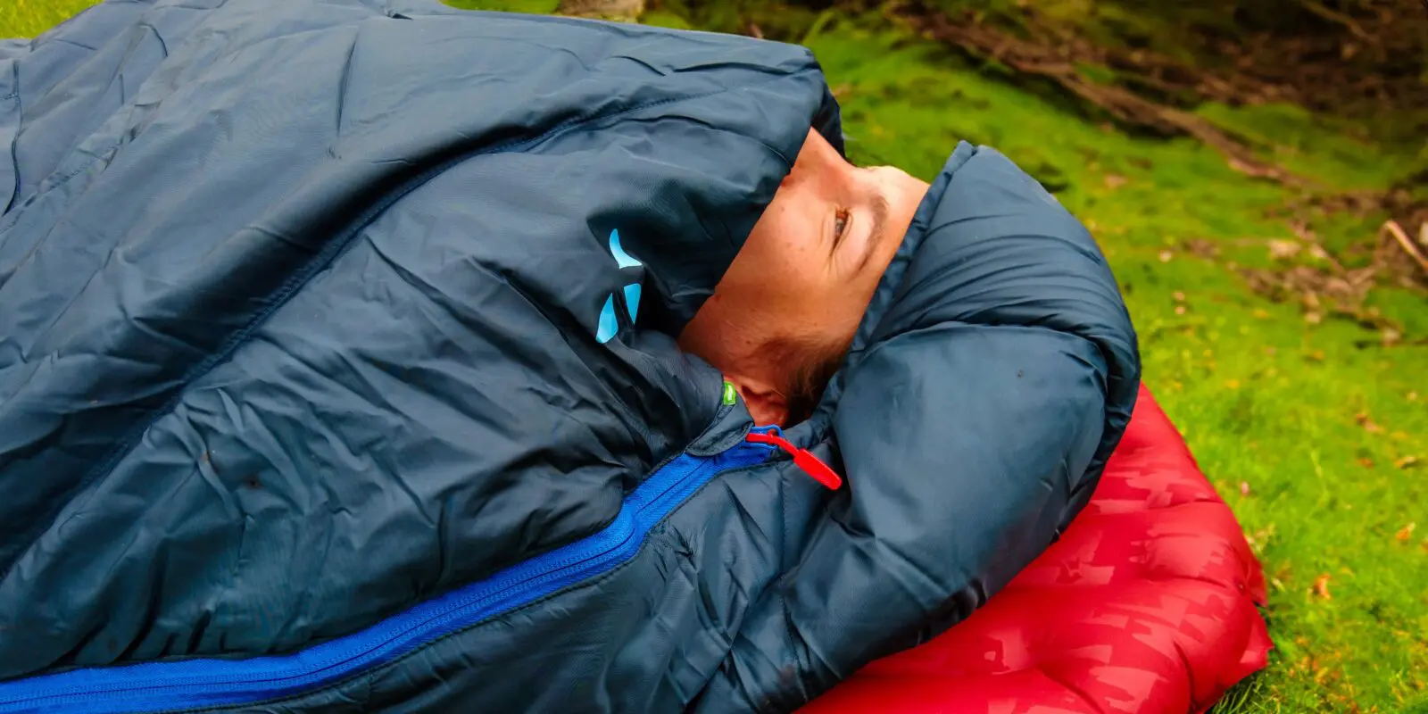 person lying in their sleeping bag