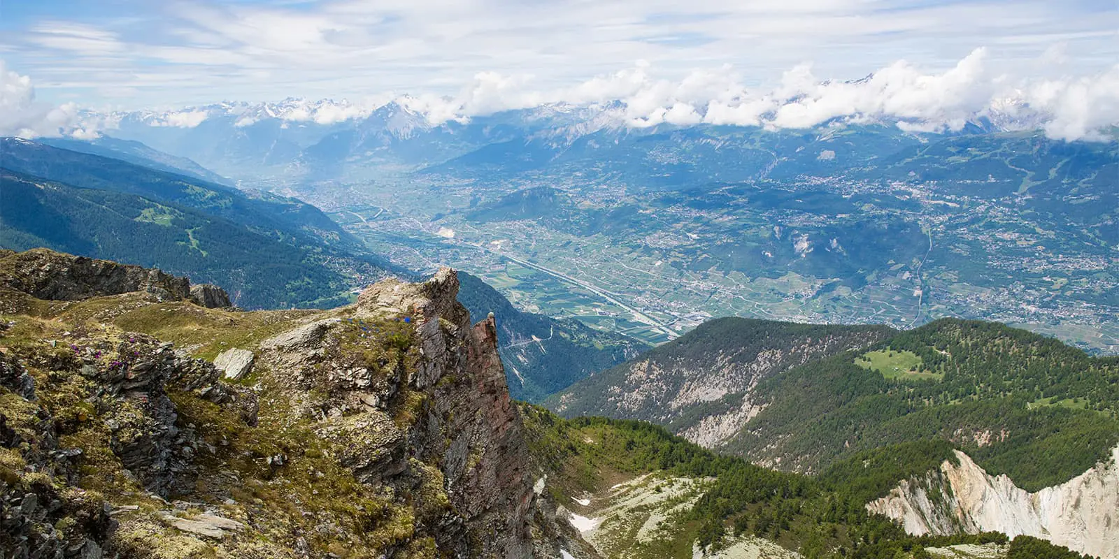 panoramic view over mountain valley from the Illhorn mountain top in Switzerland