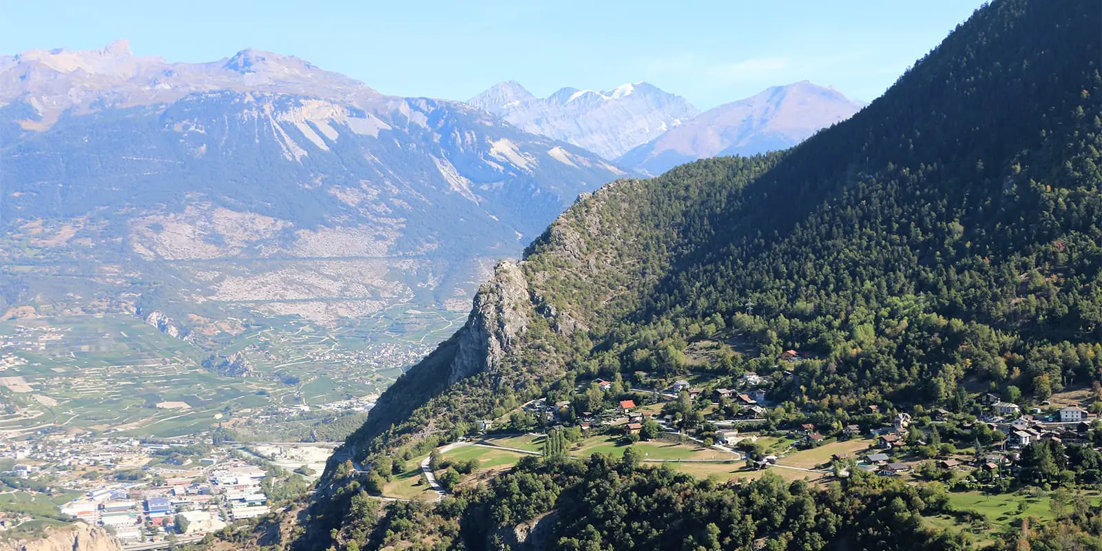 small town on green mountain next to valley
