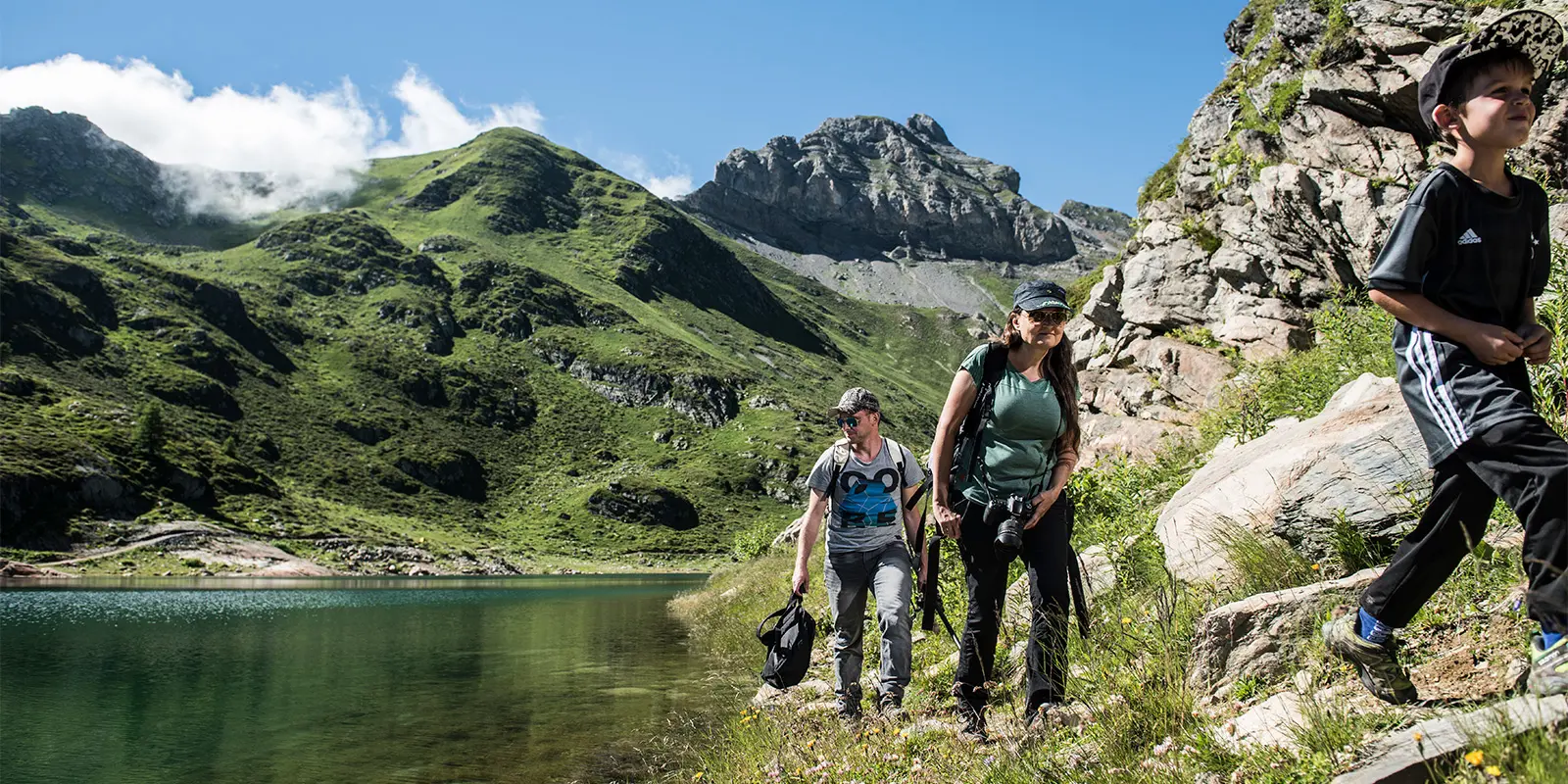 family hiking near mountain lake on the Tour du Grand-Chavalard