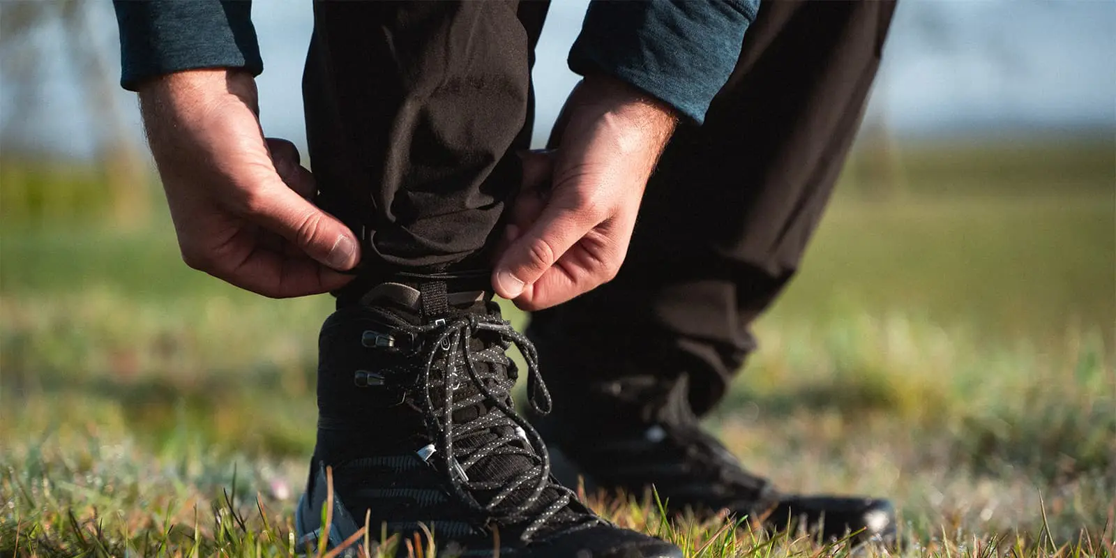 person adjusting his Maier Sports Nil outdoor pants