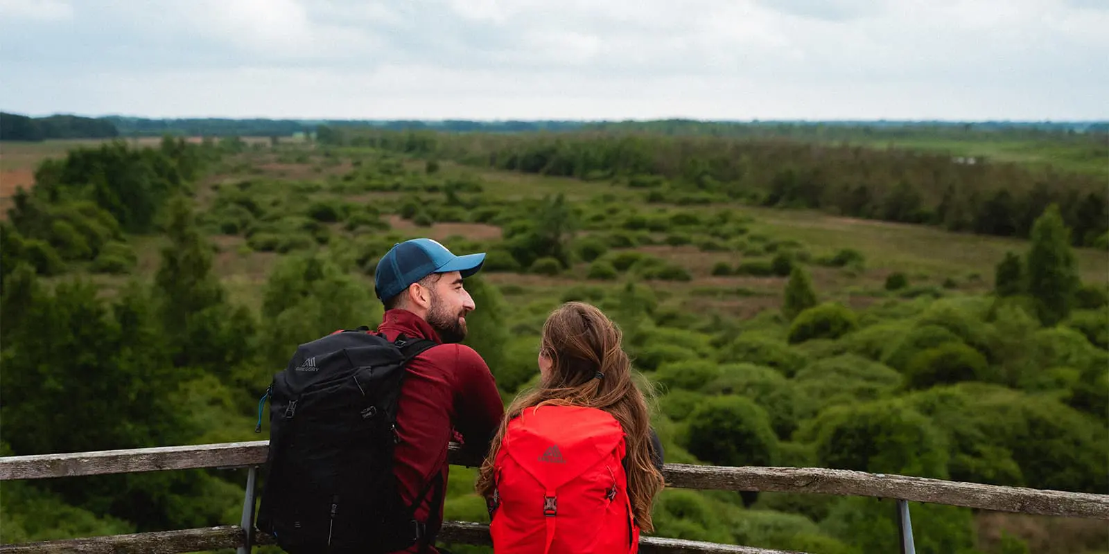 couple looking out over green countryside from vantage point