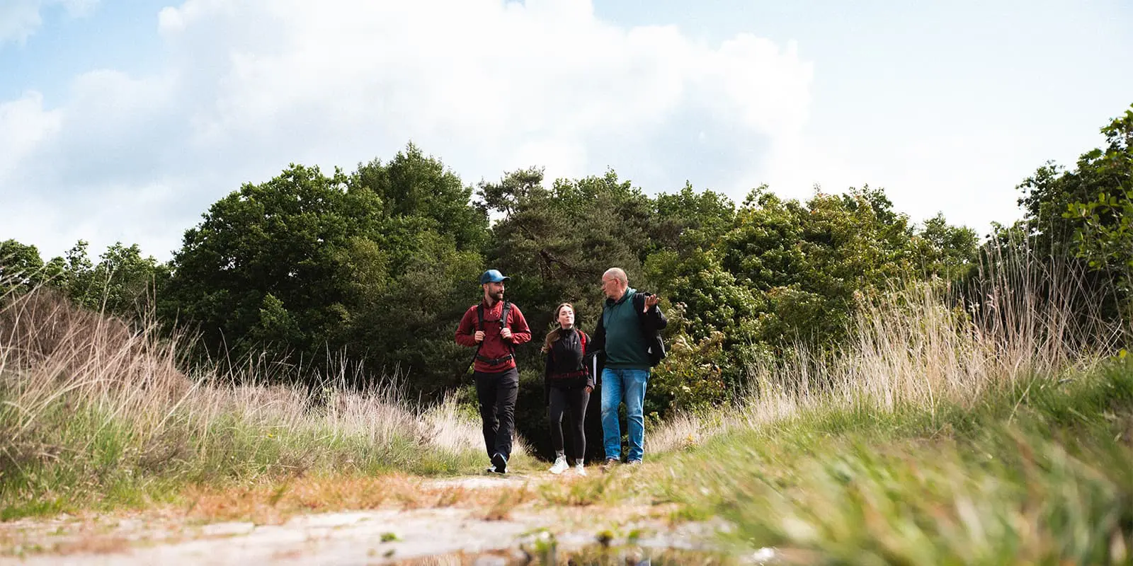 guide talking to two hikers on nature trail in the Netherlands