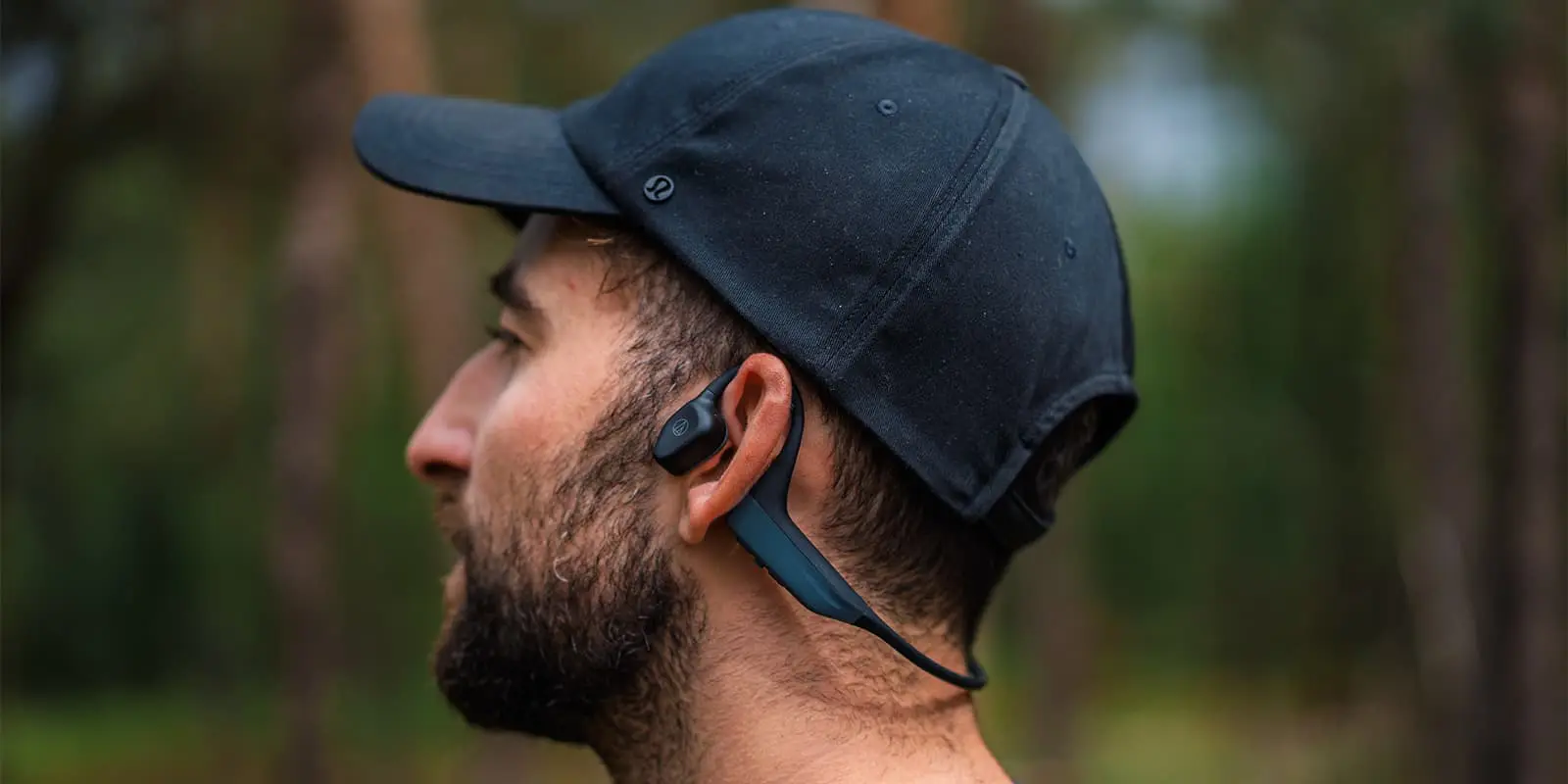 person wearing open-ear bluetooth headphone