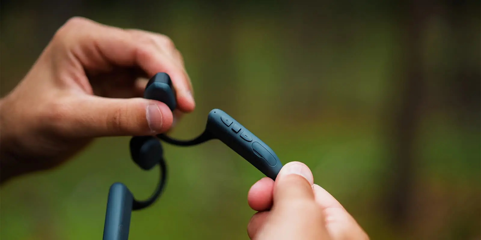 close up shot of the buttons on a open-ear bluetooth headphone from Audio Technica