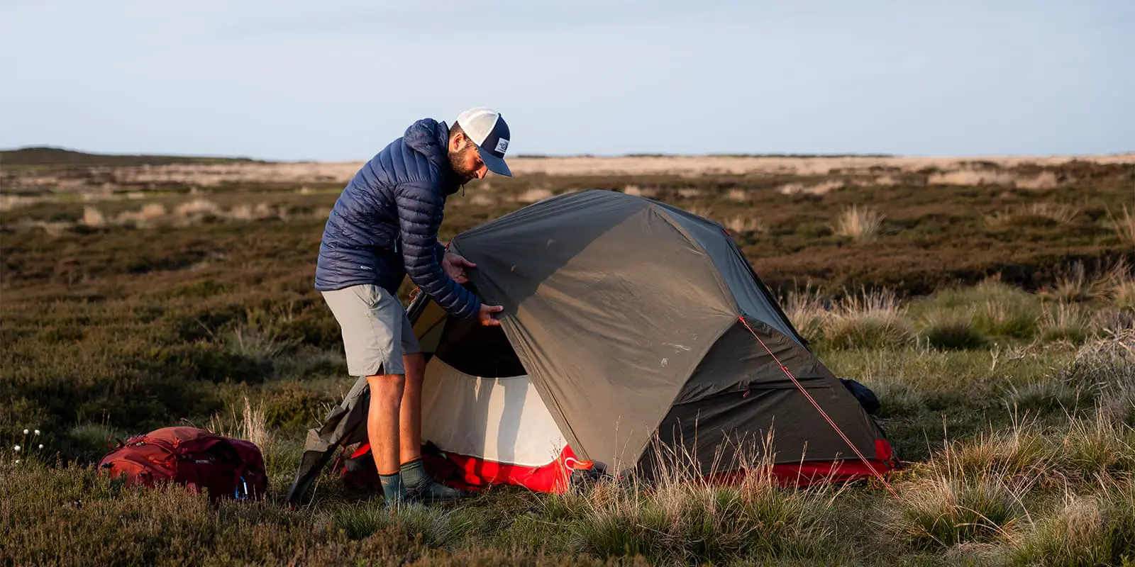 person standing by his MSR Hubba Hubba tent in Englisch countryside