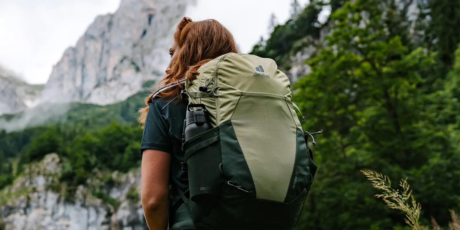 person wearing Deuter Futura 23 backpack looking up to mountain top in the Austrian Alps