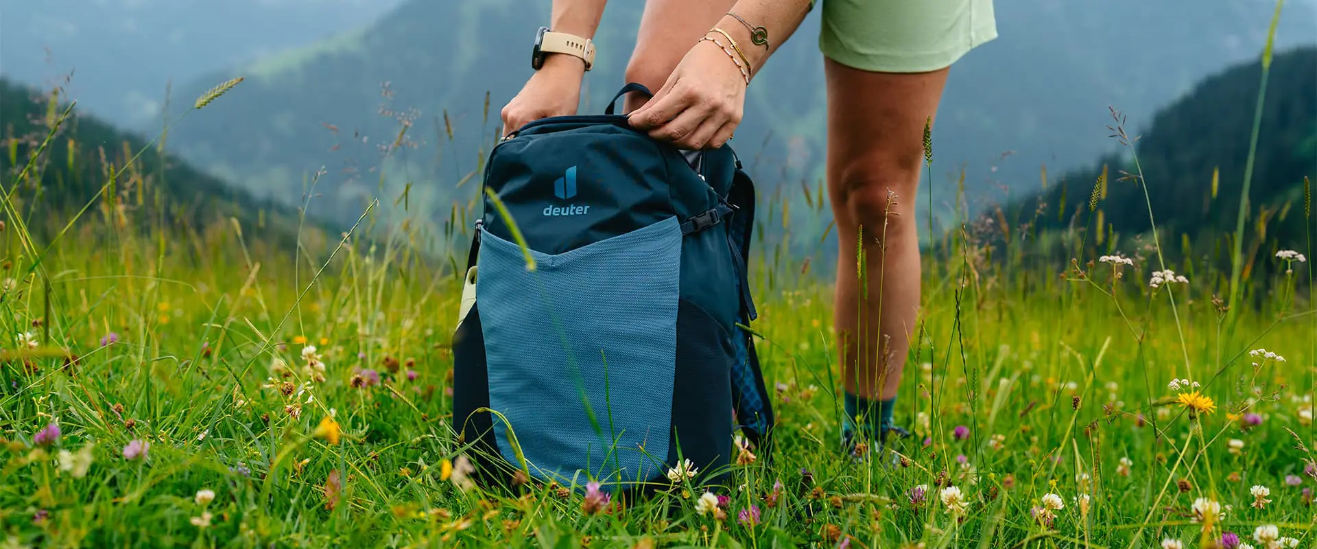 Deuter speed lite in the grass with mountains in the background