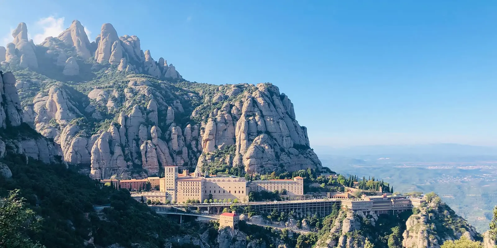 Montserrat monastery with blue sky and mountains in background