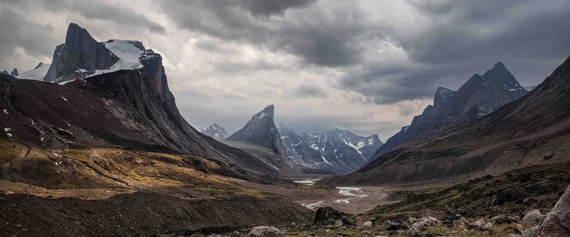 Granite walls lean over a valley on the Akshayuk pass hiking trail
