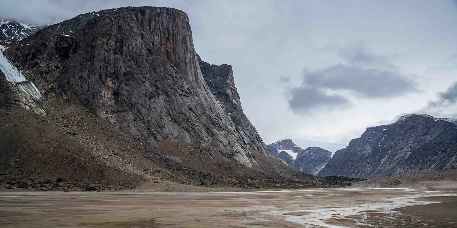 Granite walls lean over a valley on the Akshayuk pass hiking trail