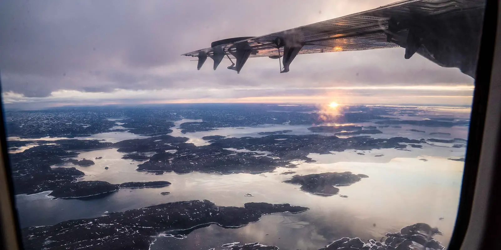 shot from inside of a plane overlooking Auyuittuq National Park on Baffin Island