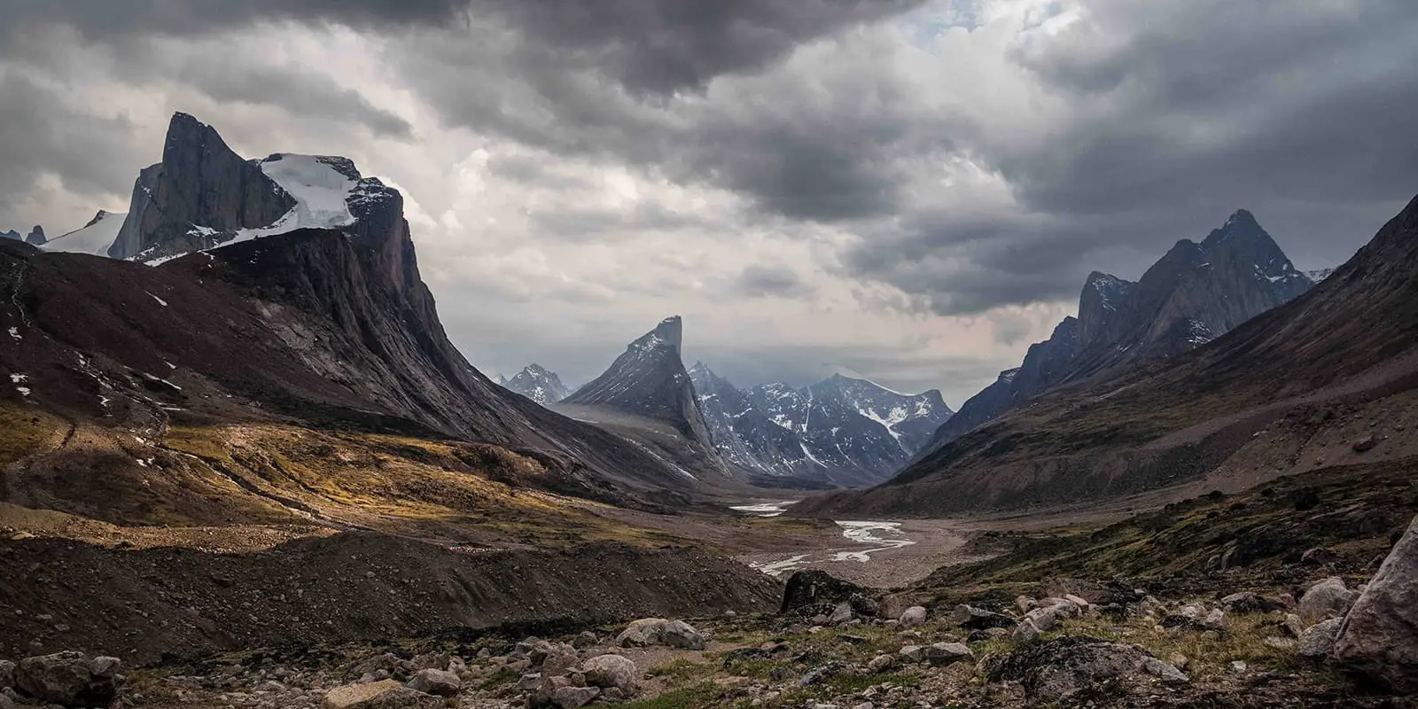 Granite walls lean over a valley on the Akshayuk pass hiking trail