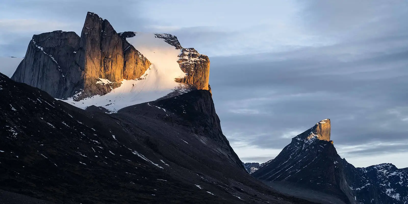 sun hitting the top of rugged peaks on Baffin Island