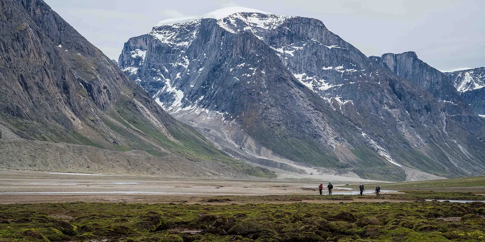 Granite walls lean over a valley on the Akshayuk pass hiking trail