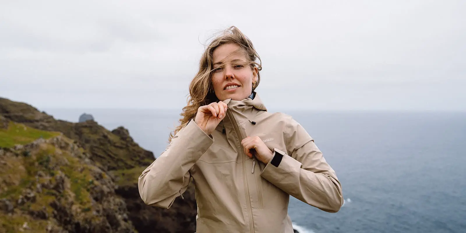 person zipping up Cortazu AR hardshell jacket