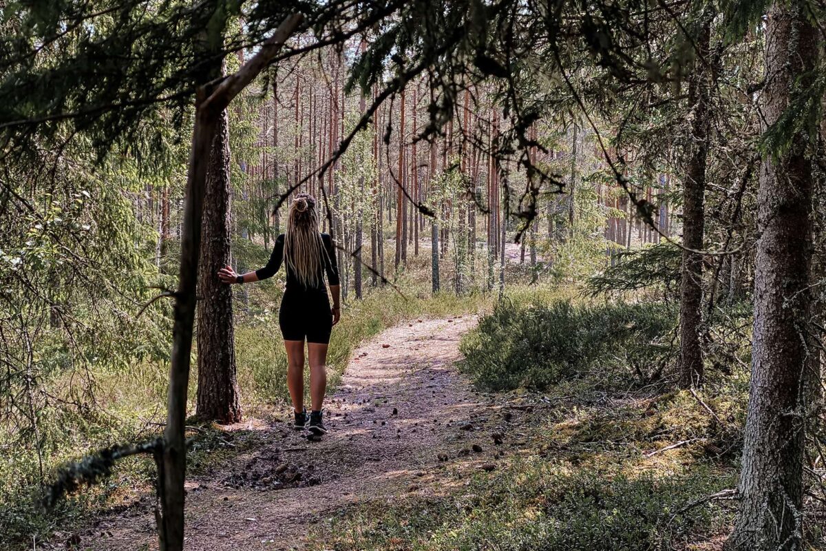 Women hiking on small forest path