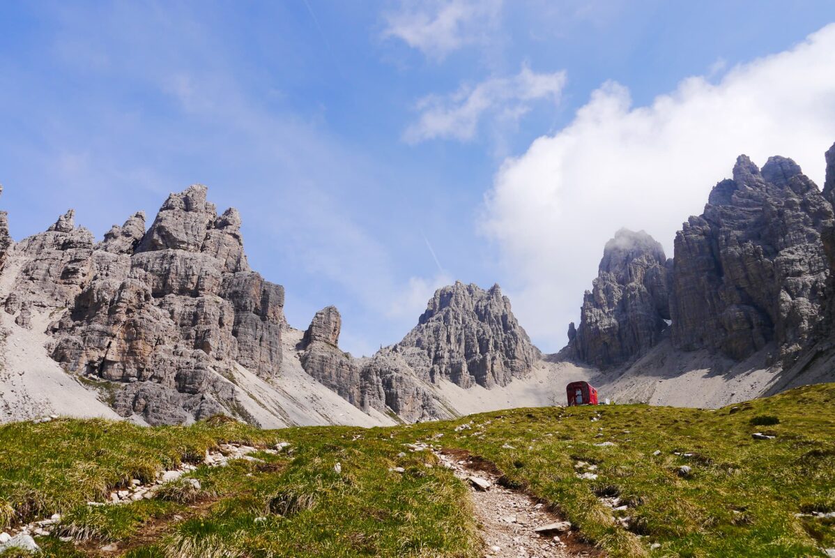 Mountain path leading up to basic shelter in the Dolomites mountains
