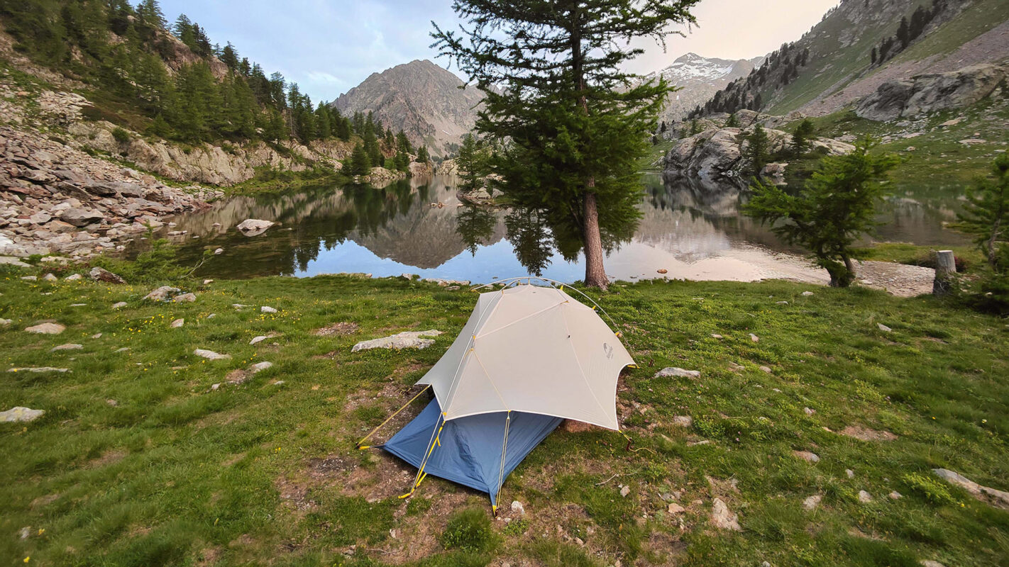 Tent pitched near mountain lake, outdoor Maritime Alps