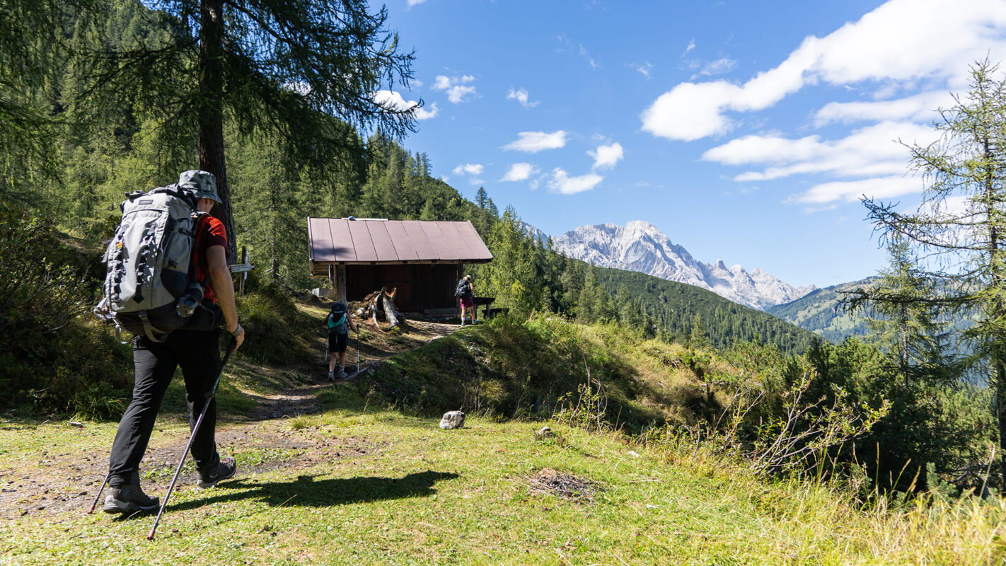 Man hiking toward mountain hut