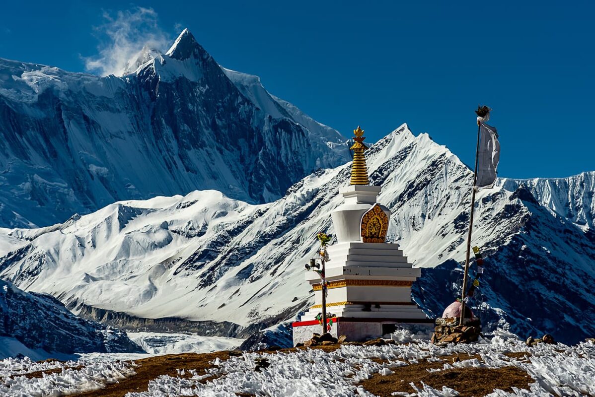 temple in middle of snow covered mountains