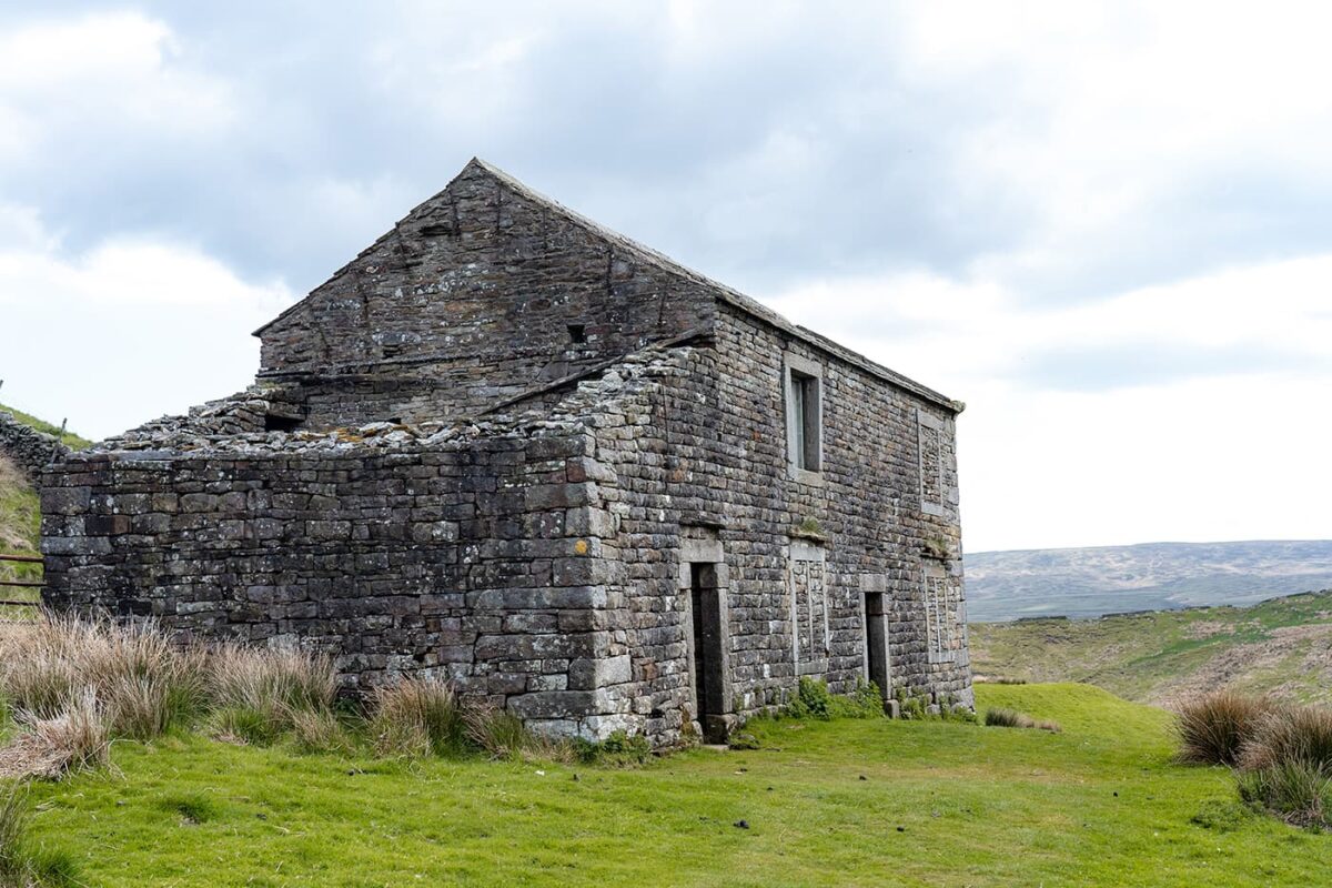 old stone house in green landscape