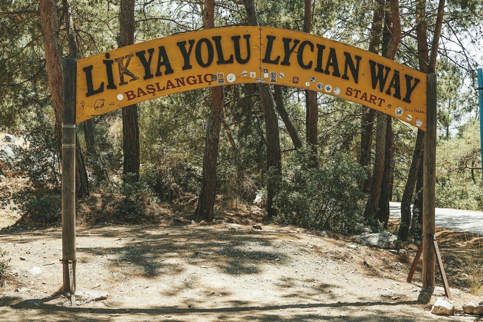 Wooden arch with text on it in forest