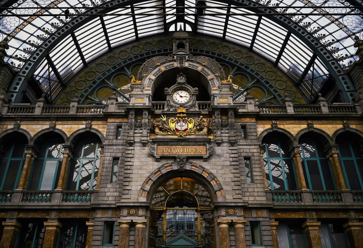 View of big clock inside of old train station in Antwerp