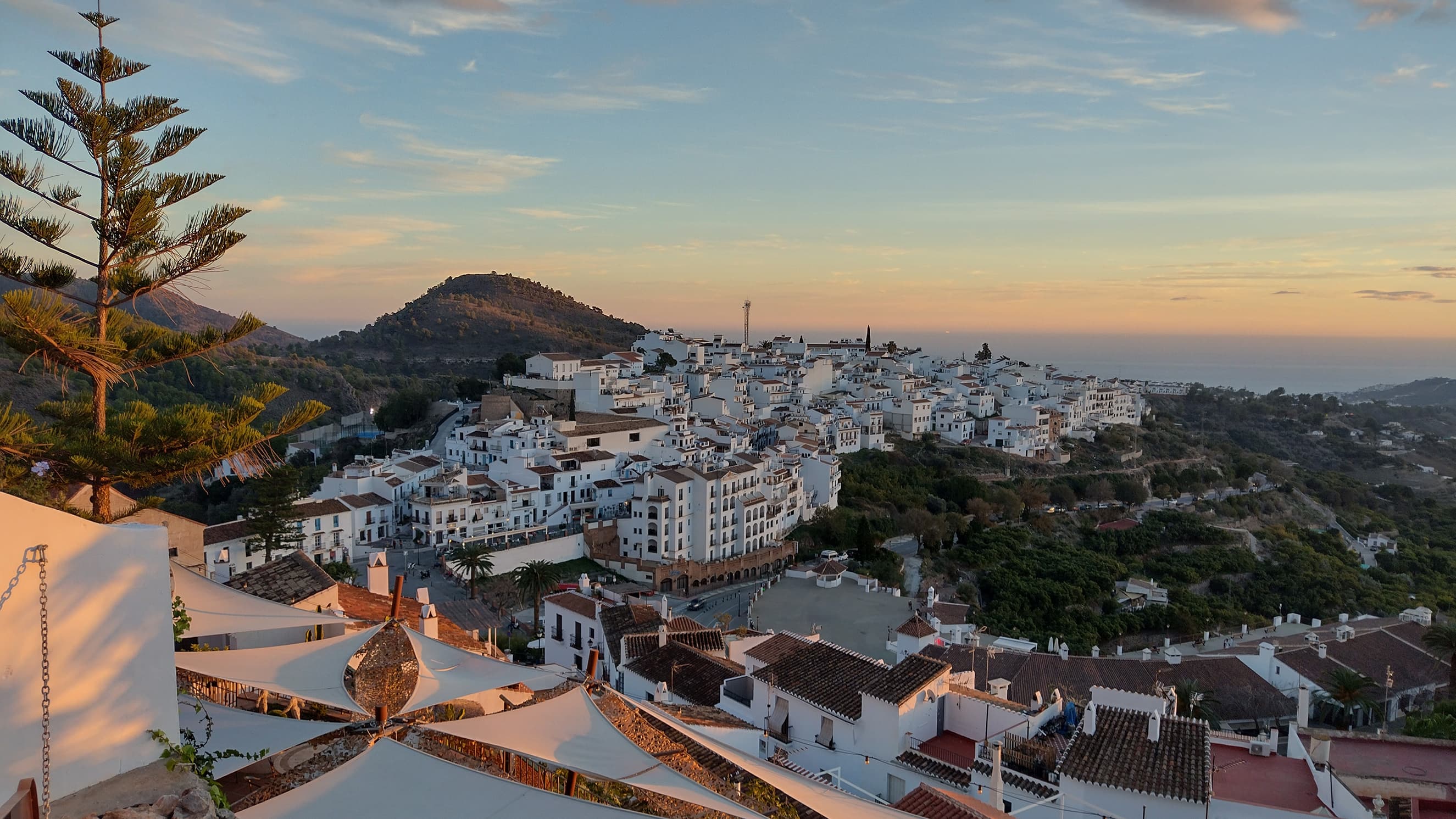 White houses in coastal town near the sea during sunset