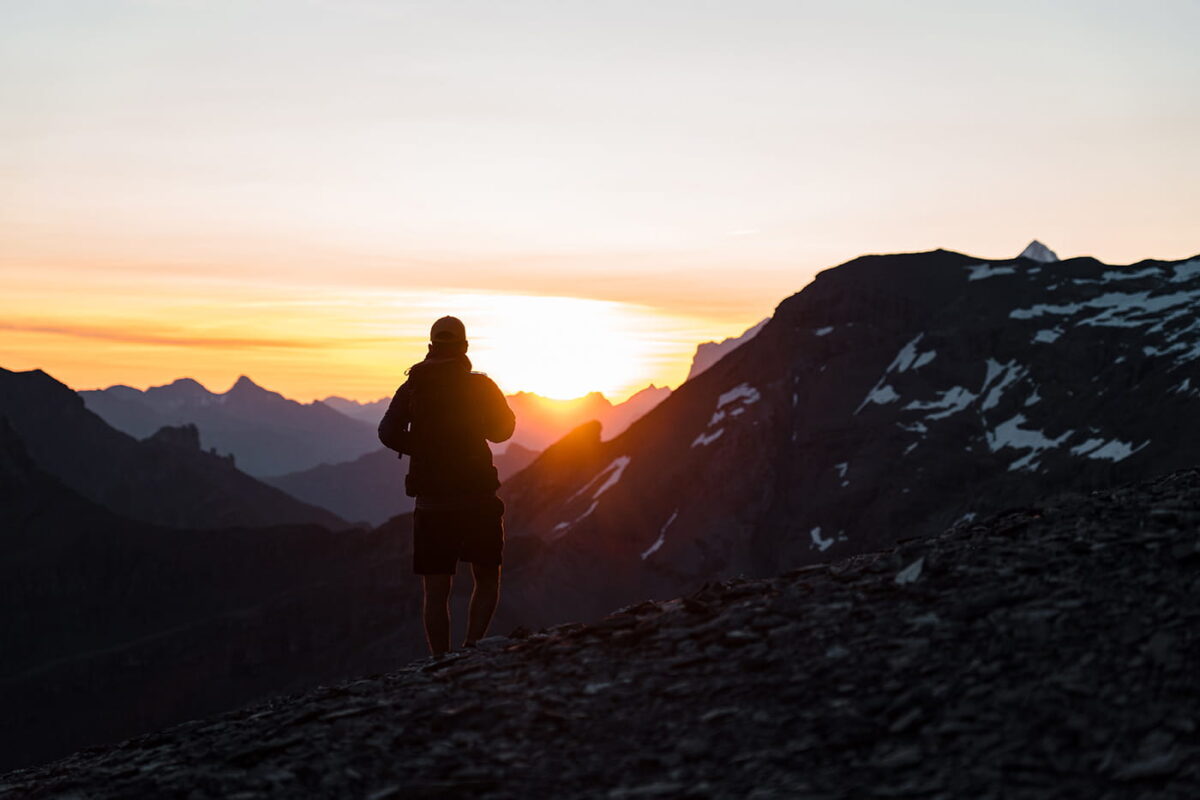 silhouet of man in the mountains during sunrise