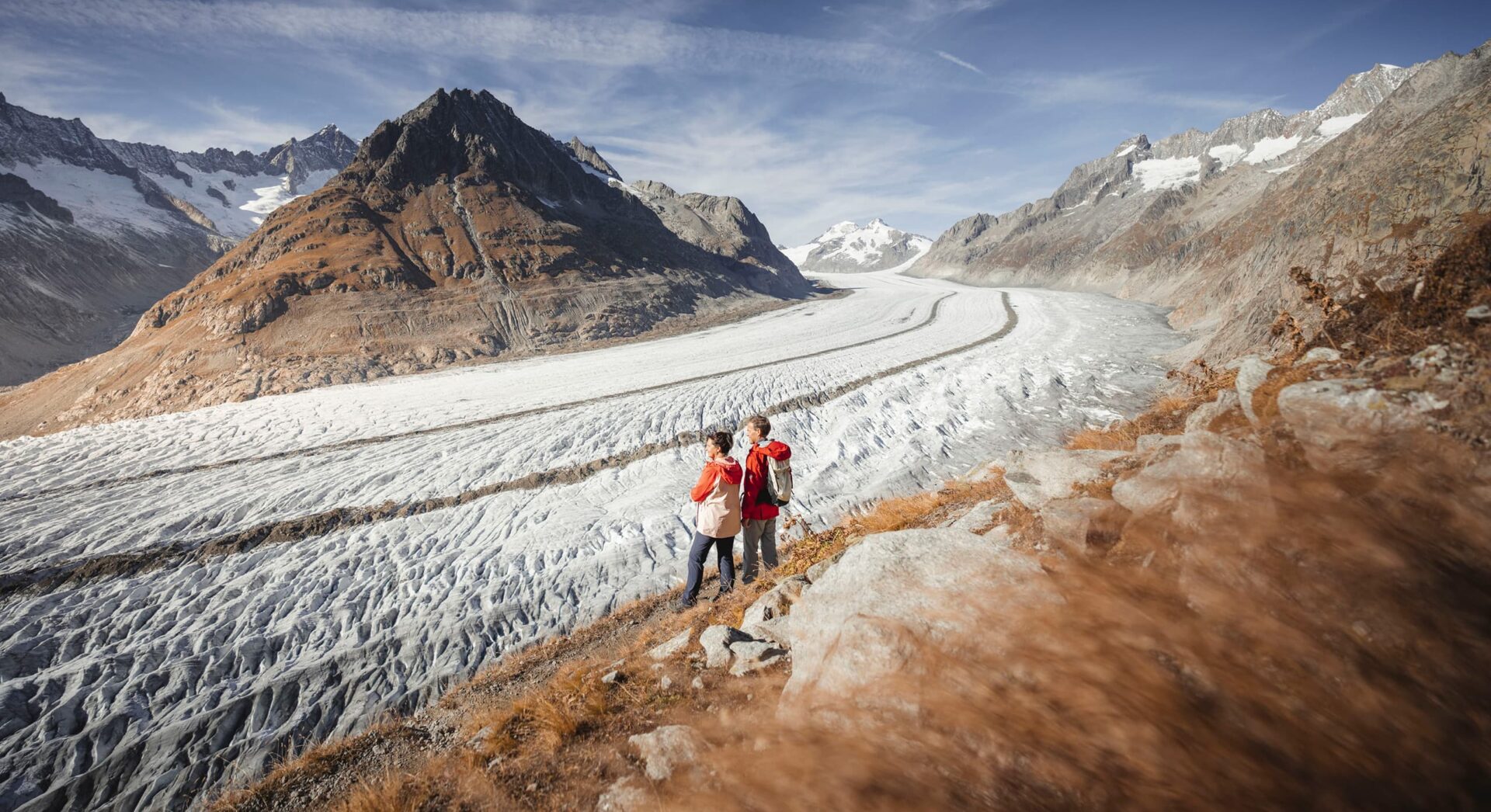couple looking at a glacier in the mountains