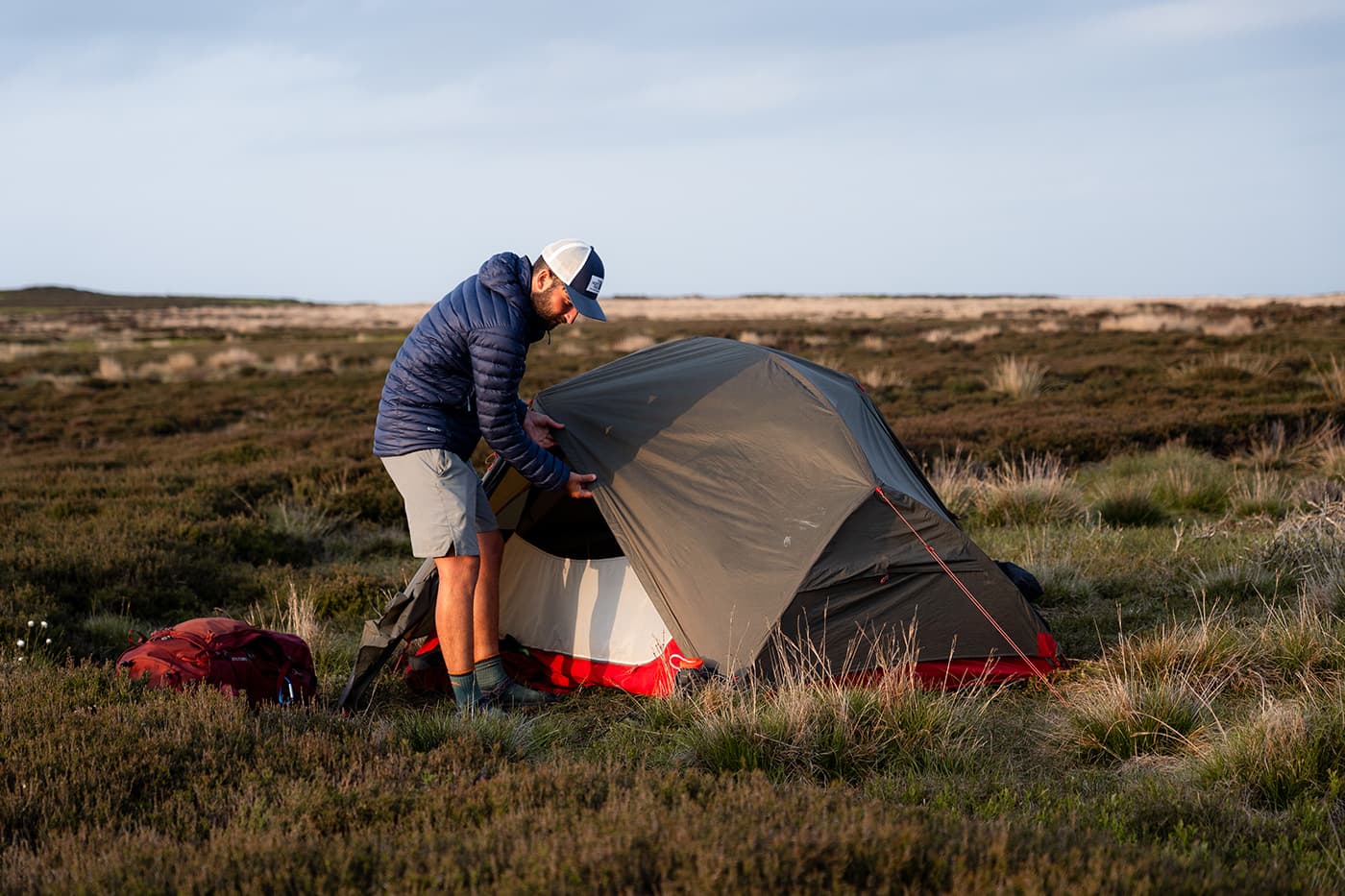 man pitching his tent
