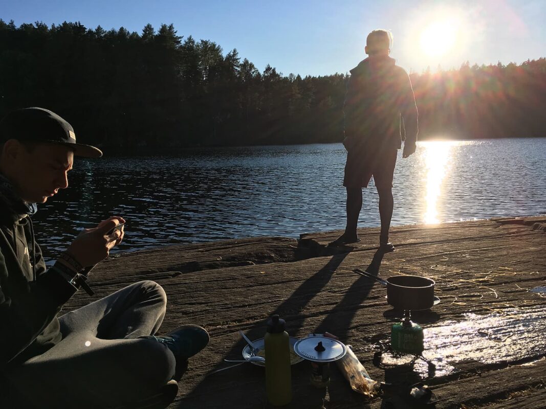 people making food near the water