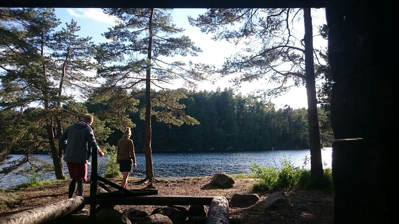 two persons walking towards water