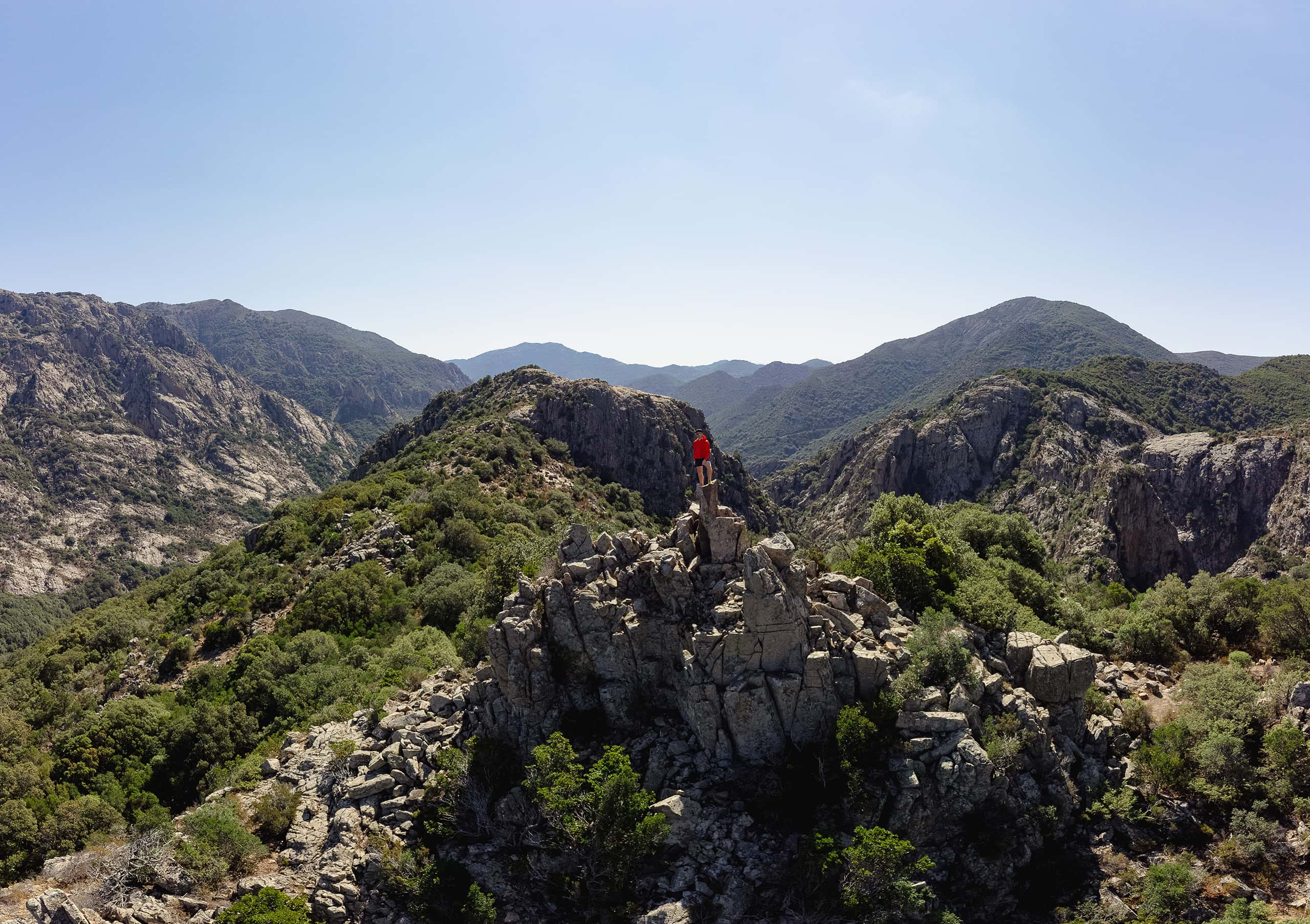 man standing on mountain peak