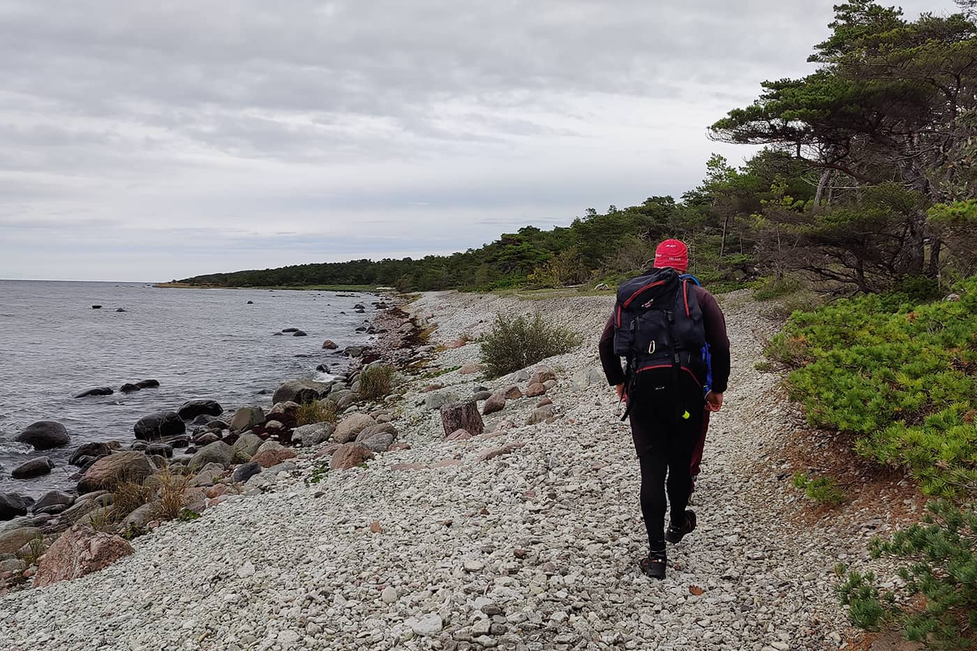 man hiking on rocky beach