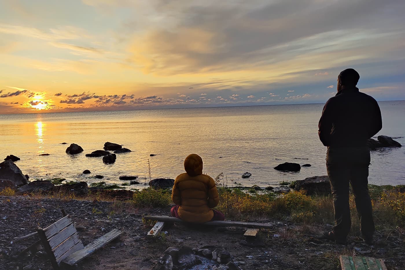 people looking at sunset at the beach