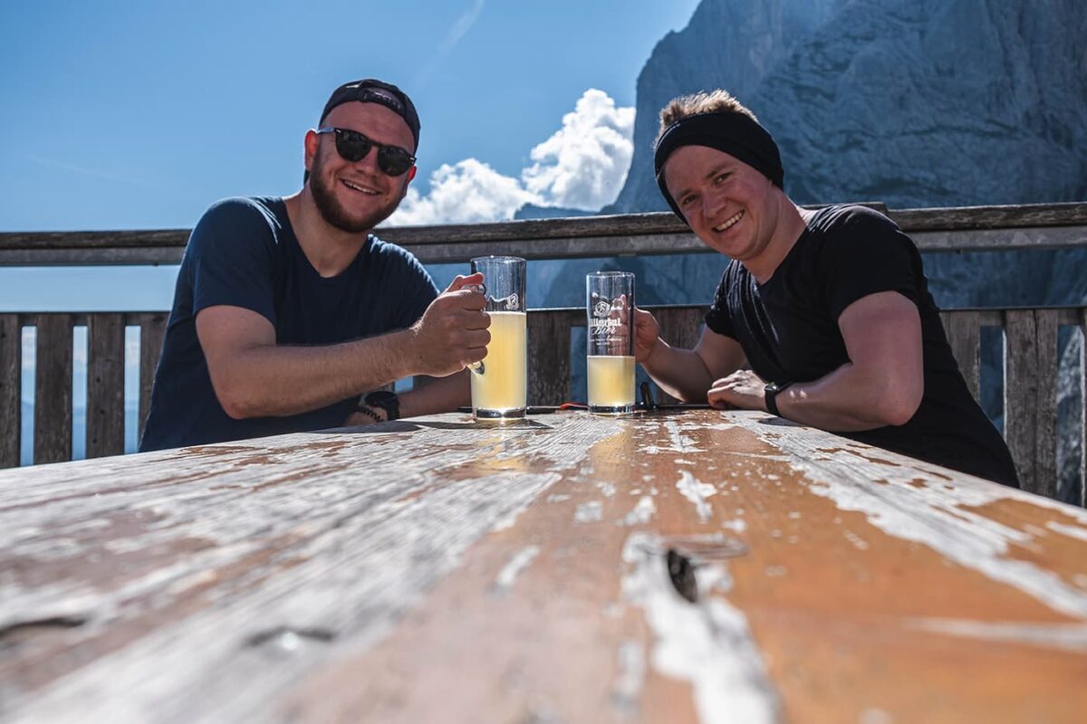 two men drinking a beer
