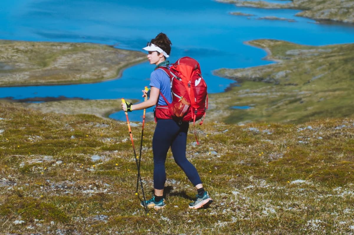 women hiking near body of water