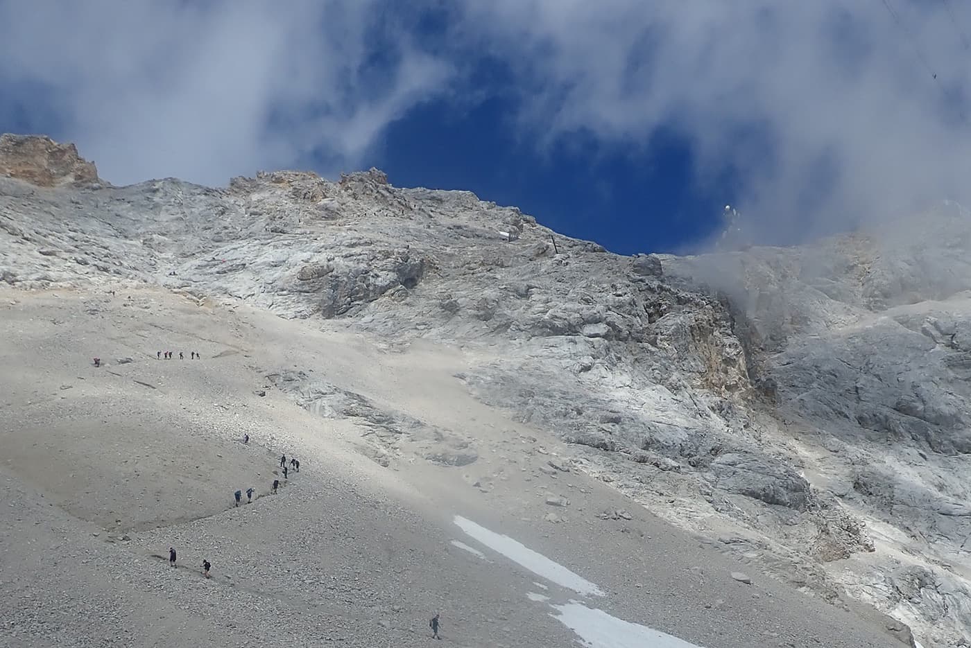 people hiking up mountain top