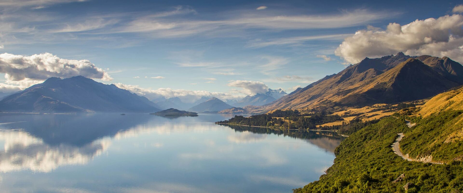 body of water near green landscape